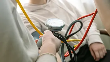 Jugendliche erhalten eine Einführung in das Messen des Blutdrucks mit einem medizinischen Gerät.